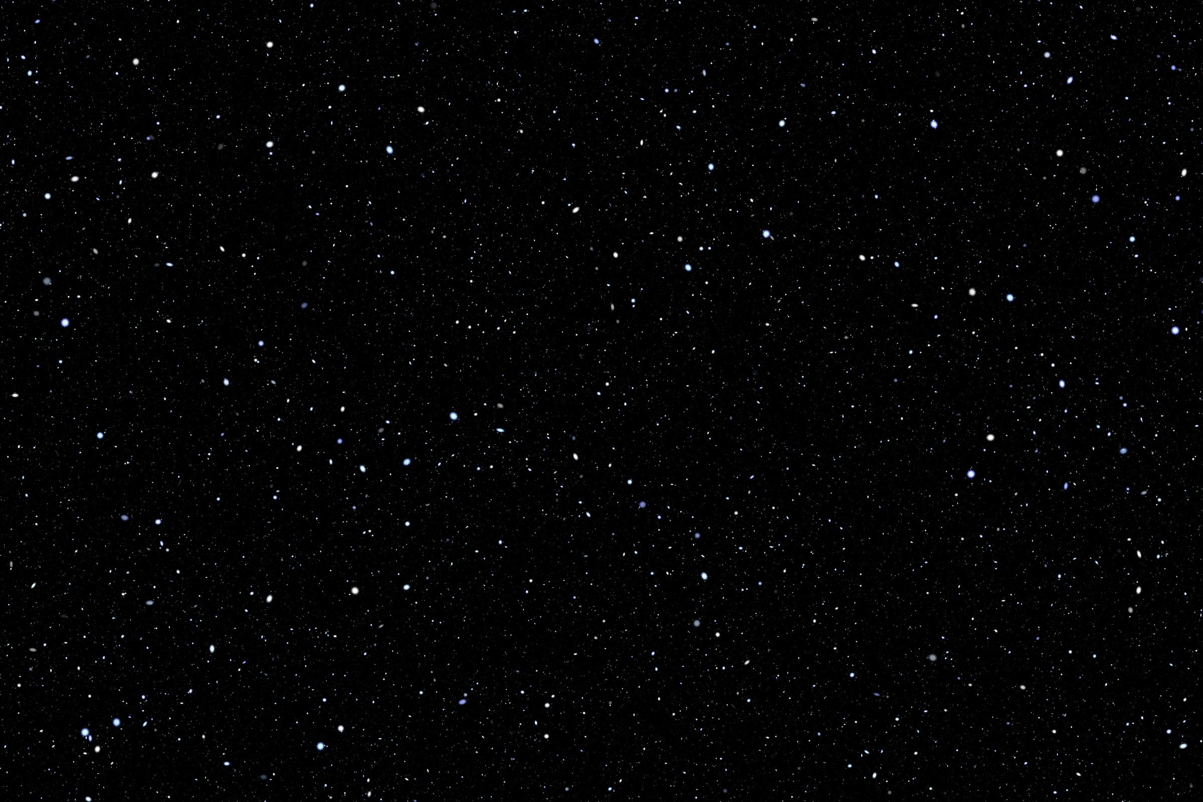 Realistic space sky which is black with stars scattered across.